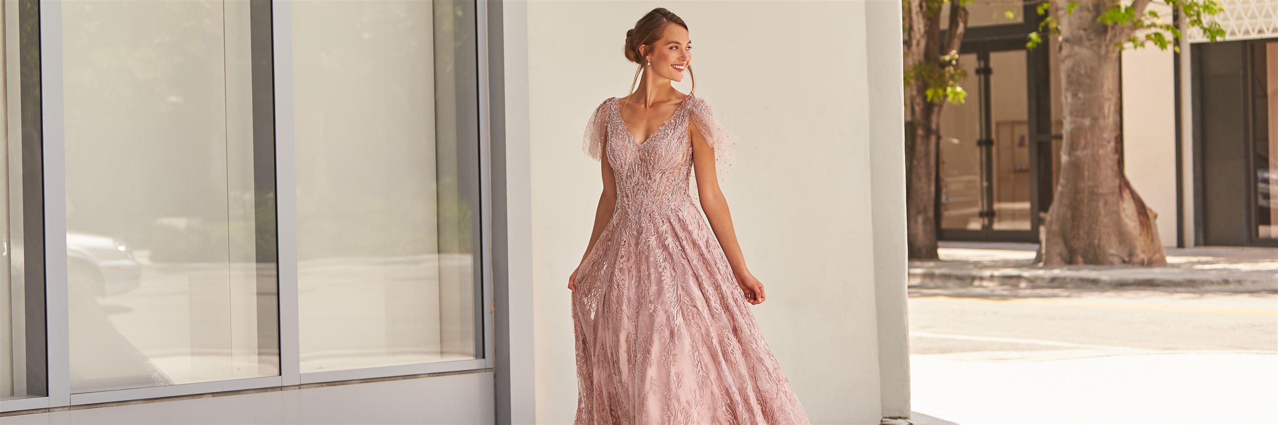 Model wearing pale pink mother of the bride dress